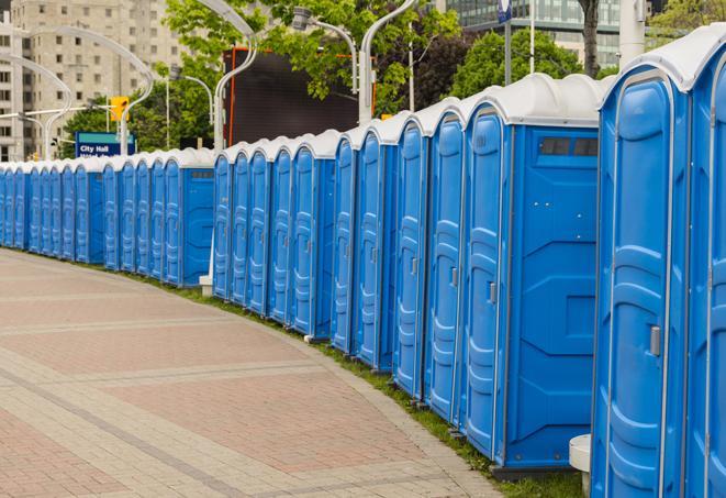 a line of portable restrooms at a sporting event, providing athletes and spectators with clean and accessible facilities in Arcola, TX